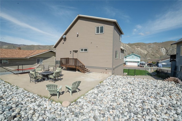 back of house featuring a patio, fence, and a mountain view
