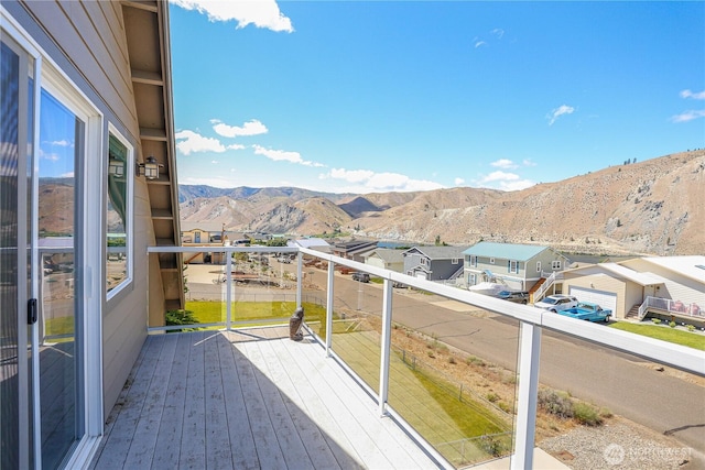 balcony featuring a residential view and a mountain view