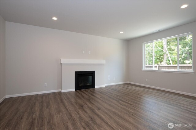 27105 30th Pl S Unit 21, Kent, WA 98032 - unfurnished living room with a glass covered fireplace, recessed lighting, dark wood-style flooring, and baseboards