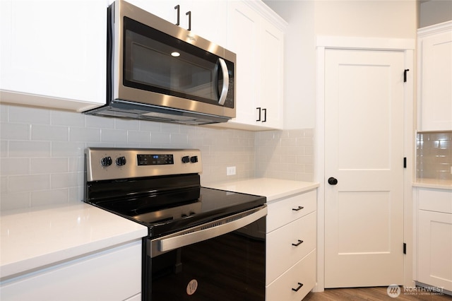 27105 30th Pl S Unit 21, Kent, WA 98032 - kitchen featuring backsplash, white cabinets, and stainless steel appliances