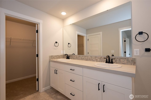 27105 30th Pl S Unit 21, Kent, WA 98032 - full bath with a walk in closet, double vanity, a sink, and backsplash