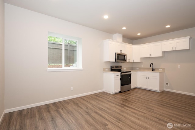 27105 30th Pl S Unit 21, Kent, WA 98032 - kitchen featuring wood finished floors, recessed lighting, baseboards, and stainless steel appliances