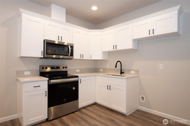 27105 30th Pl S Unit 21, Kent, WA 98032 - kitchen featuring a sink, light countertops, appliances with stainless steel finishes, white cabinetry, and dark wood-type flooring