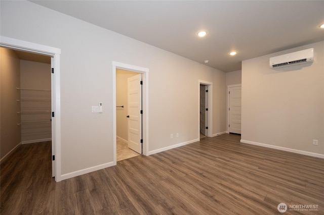 27105 30th Pl S Unit 21, Kent, WA 98032 - unfurnished room featuring baseboards, a wall unit AC, and wood finished floors