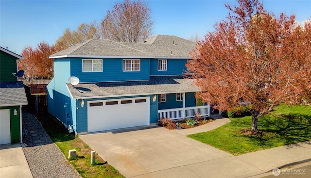 2335 Hawk Dr, Walla Walla, WA 99362 - view of front facade featuring driveway, a front lawn, a garage, a shingled roof, and covered porch