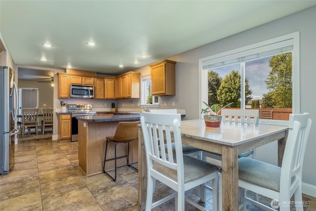 2335 Hawk Dr, Walla Walla, WA 99362 - kitchen featuring dark countertops, a center island, recessed lighting, and stainless steel appliances