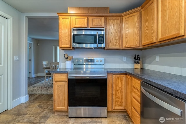 2335 Hawk Dr, Walla Walla, WA 99362 - kitchen with dark countertops, baseboards, appliances with stainless steel finishes, and beverage cooler