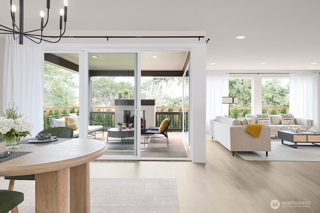entryway featuring recessed lighting, an inviting chandelier, and wood finished floors