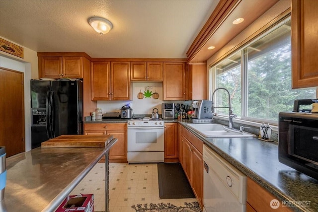 515 N 188th St, Shoreline, WA 98133 - kitchen featuring white appliances, brown cabinets, light flooring, and dark countertops