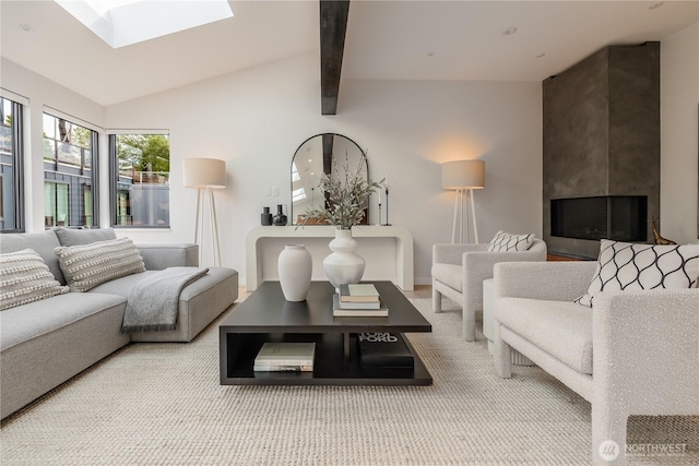 living room featuring vaulted ceiling with skylight, a fireplace, and carpet flooring