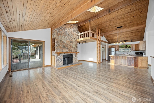 unfurnished living room with wooden ceiling, vaulted ceiling, and wood finished floors