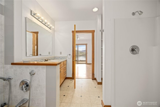 full bathroom with vanity, tile patterned floors, and a shower