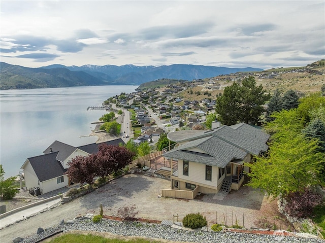 drone / aerial view with a residential view and a water and mountain view