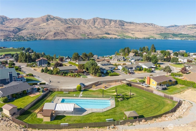 drone / aerial view featuring a water and mountain view