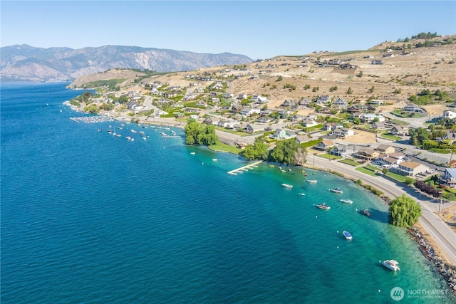 bird's eye view with a water and mountain view and a residential view