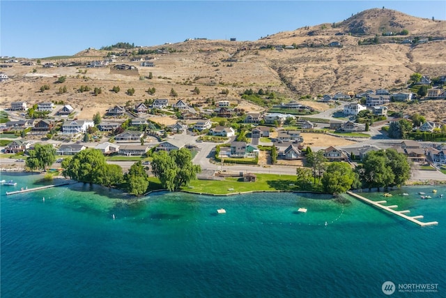 bird's eye view with a water and mountain view and a residential view
