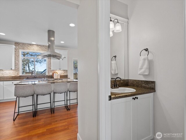 5258 S 285th St, Auburn, WA 98001 - bathroom with tasteful backsplash, recessed lighting, vanity, and wood finished floors
