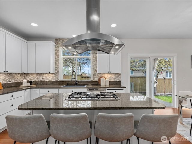 5258 S 285th St, Auburn, WA 98001 - kitchen featuring tasteful backsplash, white cabinets, a sink, stainless steel gas stovetop, and island range hood