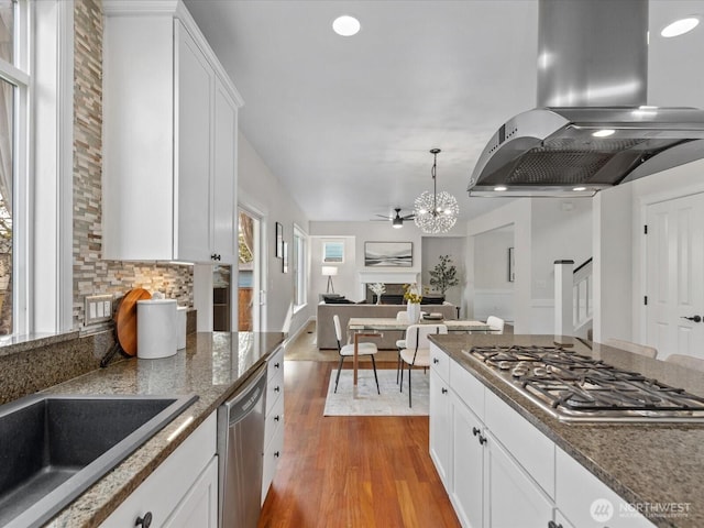 5258 S 285th St, Auburn, WA 98001 - kitchen with white cabinets, open floor plan, appliances with stainless steel finishes, wood finished floors, and island exhaust hood
