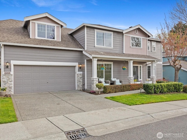 5258 S 285th St, Auburn, WA 98001 - view of front of home featuring a shingled roof, stone siding, covered porch, and driveway