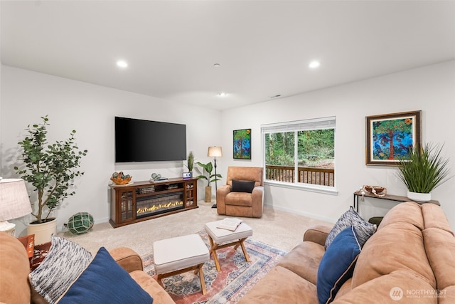 11232 Crescent Valley Dr NW, Gig Harbor, WA 98332 - carpeted living area featuring baseboards, a glass covered fireplace, and recessed lighting