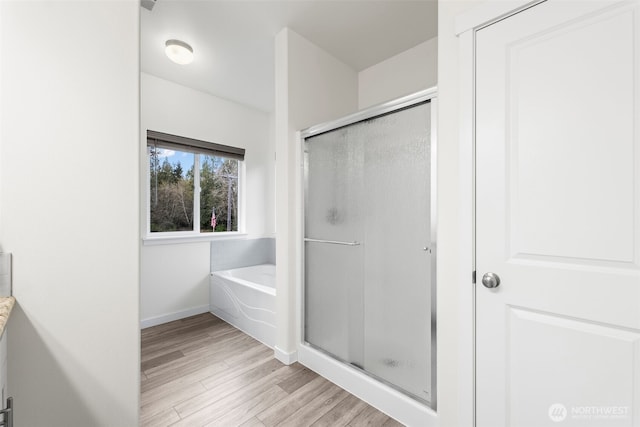 11232 Crescent Valley Dr NW, Gig Harbor, WA 98332 - bathroom with a bath, baseboards, a shower stall, and wood finished floors
