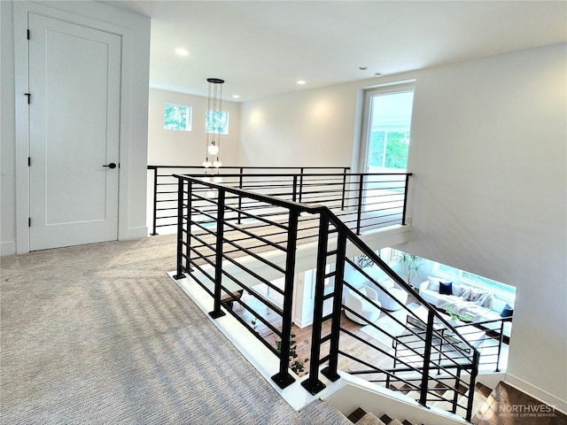 staircase with an inviting chandelier, recessed lighting, baseboards, and a wealth of natural light