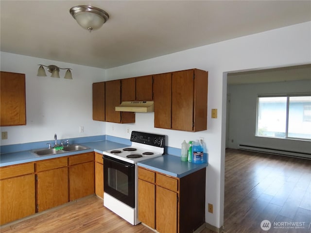 kitchen with a baseboard heating unit, electric range, under cabinet range hood, a sink, and light wood-type flooring