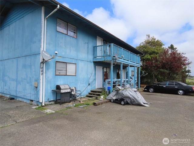 townhome / multi-family property featuring a balcony and crawl space