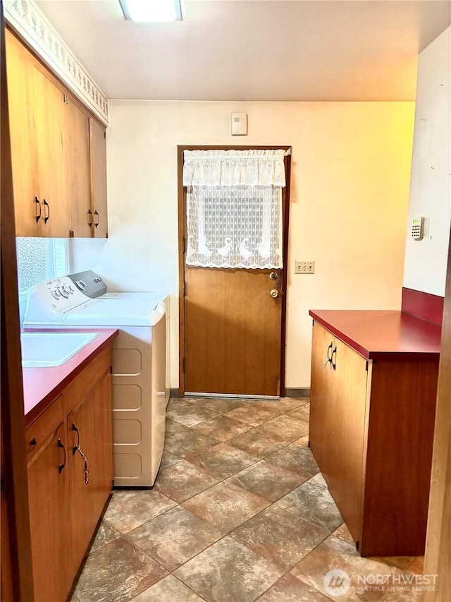115 Kakela Rd, Winlock, WA 98596 - washroom with cabinet space, washer and clothes dryer, and light stone finish flooring
