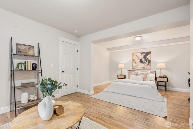 bedroom featuring baseboards and wood finished floors