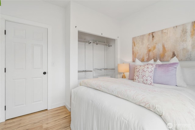 bedroom featuring wood finished floors and baseboards