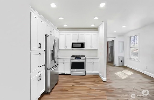 7007 48th Ave S, Seattle, WA 98118 - kitchen with appliances with stainless steel finishes, white cabinetry, light wood-style flooring, baseboards, and recessed lighting