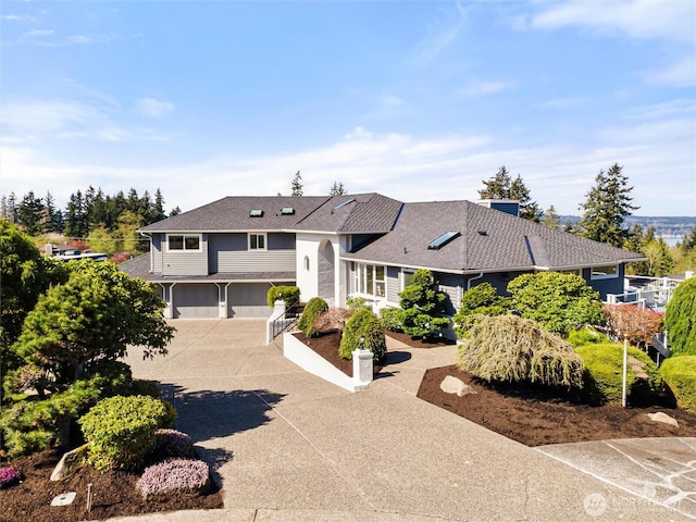view of front of property with concrete driveway and an attached garage