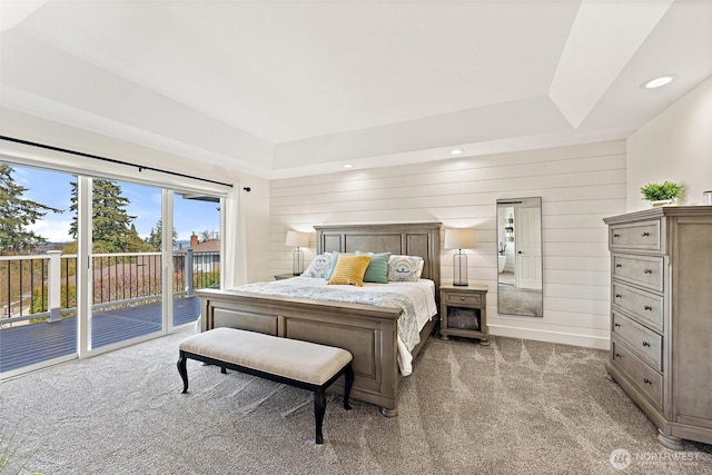 carpeted bedroom featuring wood walls, recessed lighting, and access to outside