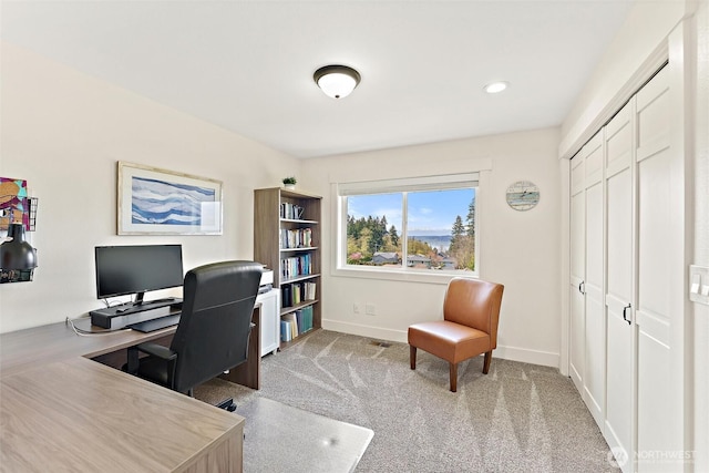 office space featuring carpet floors, baseboards, and visible vents