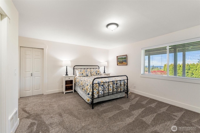 carpeted bedroom featuring baseboards and visible vents