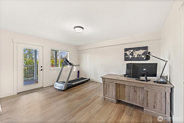 office area featuring light wood-style flooring and baseboards