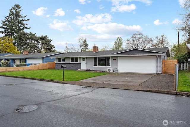 ranch-style home with driveway, a garage, a front yard, and fence
