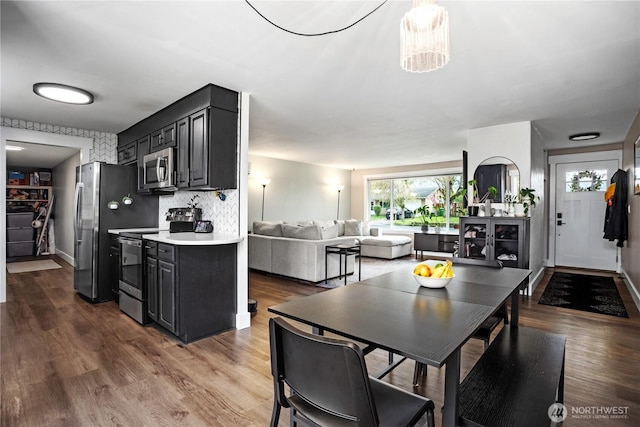 dining area with baseboards and wood finished floors
