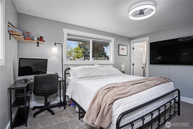 bedroom featuring baseboards and carpet