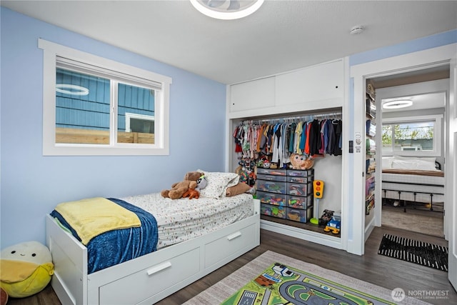 bedroom with a closet and wood finished floors