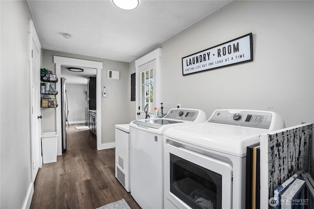 laundry room with dark wood-type flooring, laundry area, baseboards, and washing machine and dryer
