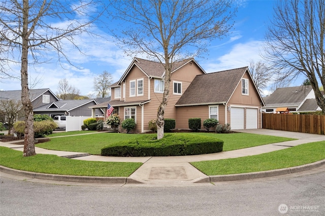 traditional-style home with driveway, a garage, fence, and a front lawn