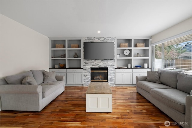 living area featuring wood finished floors and a fireplace