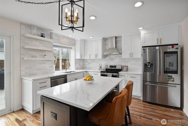 kitchen with wall chimney exhaust hood, open shelves, white cabinets, a kitchen island, and stainless steel appliances