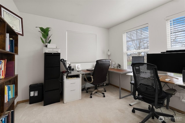 office with light colored carpet, baseboards, and a healthy amount of sunlight