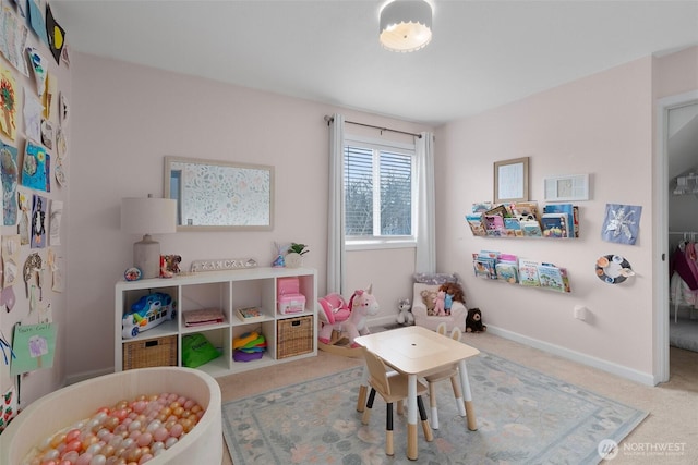 rec room featuring carpet floors and baseboards