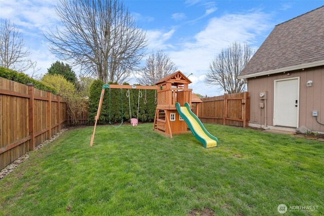 view of playground with a yard and a fenced backyard