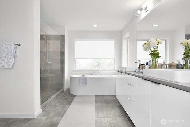 11911 SE 242nd Pl, Kent, WA 98030 - full bath featuring a freestanding tub, a sink, double vanity, recessed lighting, and a stall shower